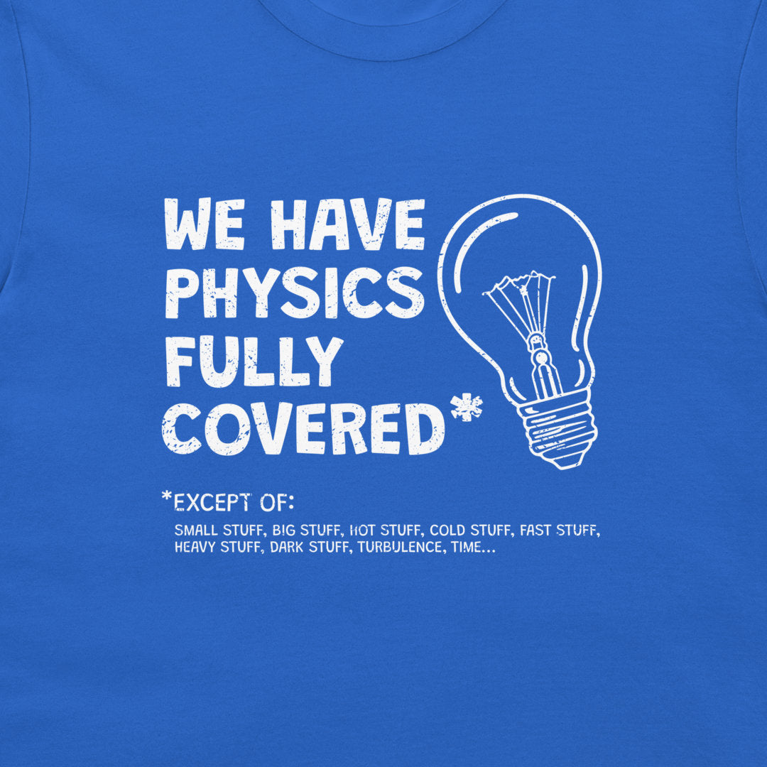 A close-up of a royal blue t-shirt featuring a white graphic print that reads 'WE HAVE PHYSICS FULLY COVERED' next to a lightbulb outline, with a humorous exception list below.