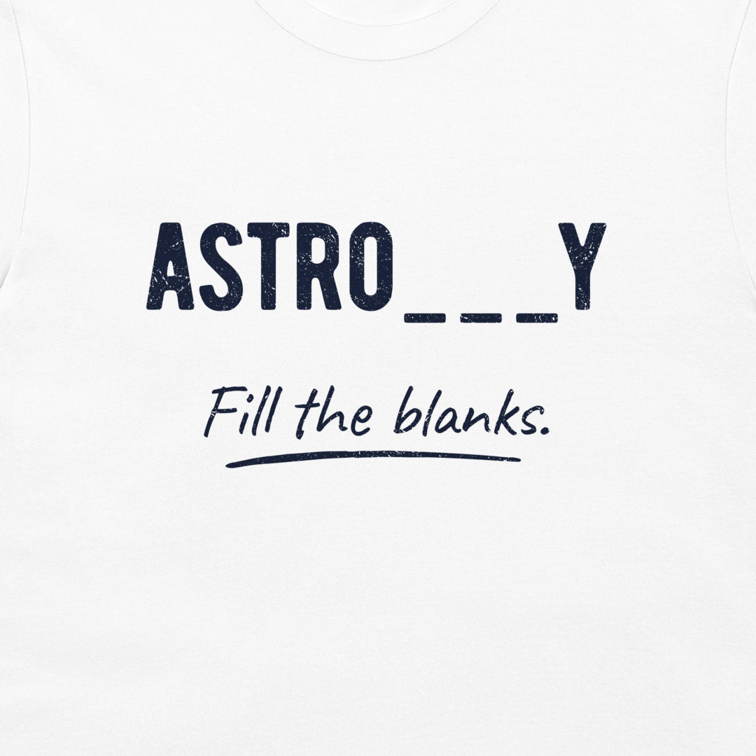 White t-shirt featuring a navy blue graphic print that reads 'ASTRO___Y' in a bold, distressed font, with 'Fill the blanks.' written below in a cursive script.