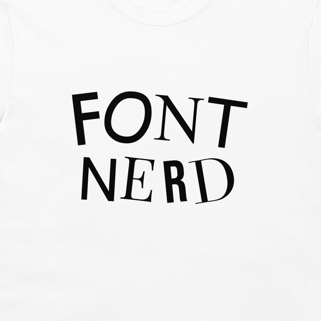 A close-up of a white t-shirt featuring the words 'FONT NERD' each letter printed in a different font across the chest.