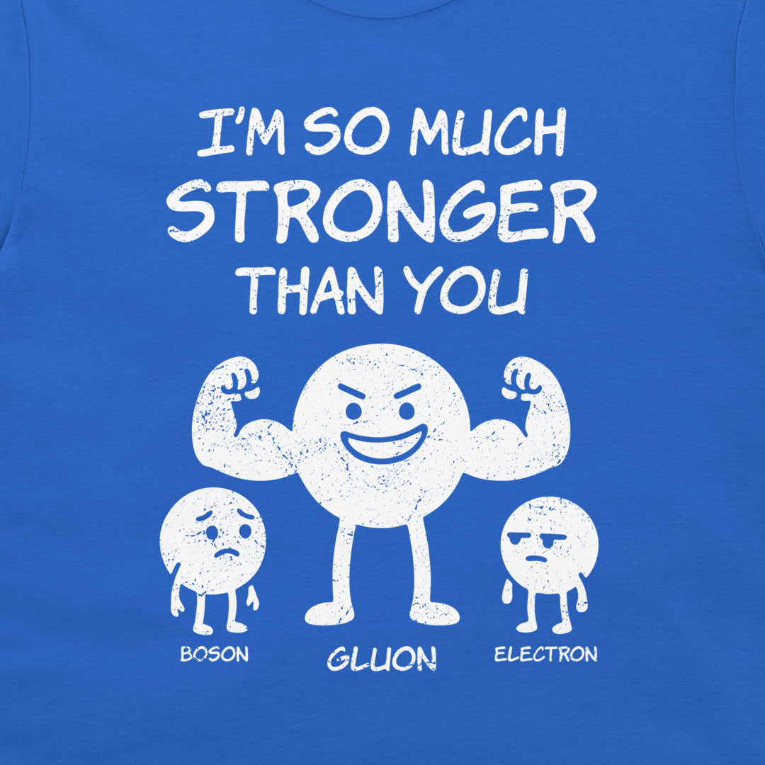 A close-up of a blue t-shirt featuring a white distressed graphic of three cartoon particles labeled 'BOSON', 'GLUON', and 'ELECTRON' with the text 'I'M SO MUCH STRONGER THAN YOU'.