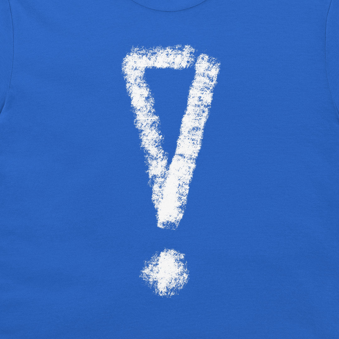 A close-up of a bright blue t-shirt, featuring a large white chalk-style exclamation mark printed on the front.
