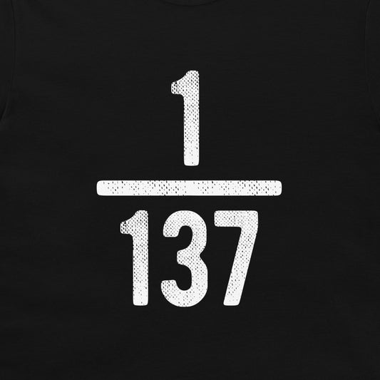 A close-up of a black t-shirt, featuring a large white distressed graphic of the fraction 1/137 on the front.