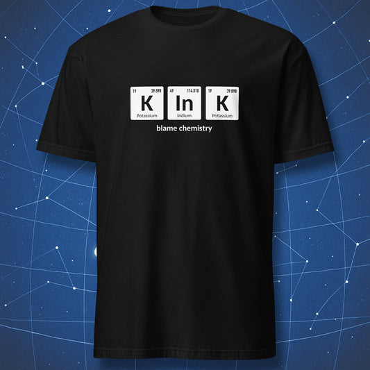 Black T-shirt featuring periodic table pun K–In–K with Potassium, Indium, and Potassium elements and text ‘blame chemistry’.