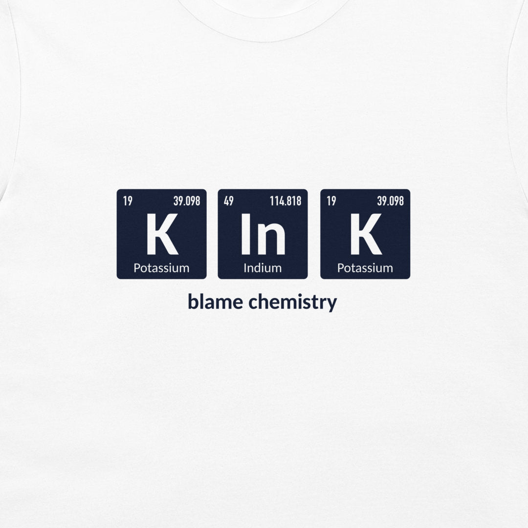 White crewneck t-shirt featuring a graphic of three dark blue periodic table style tiles spelling 'K In K' with the text 'blame chemistry' underneath.