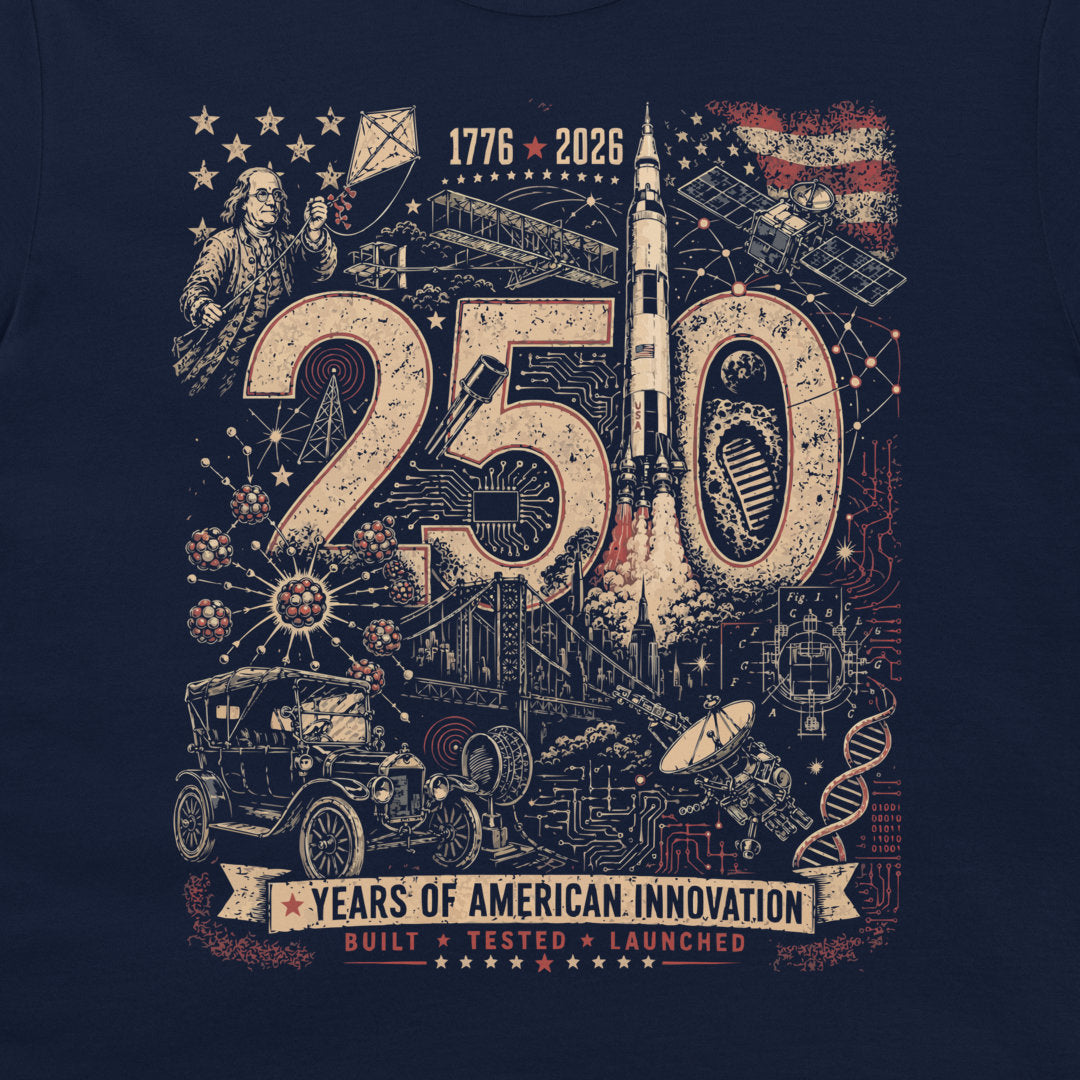A navy blue graphic t-shirt featuring a vintage-style illustration celebrating '250 Years of American Innovation' with space, automotive, and historical elements.