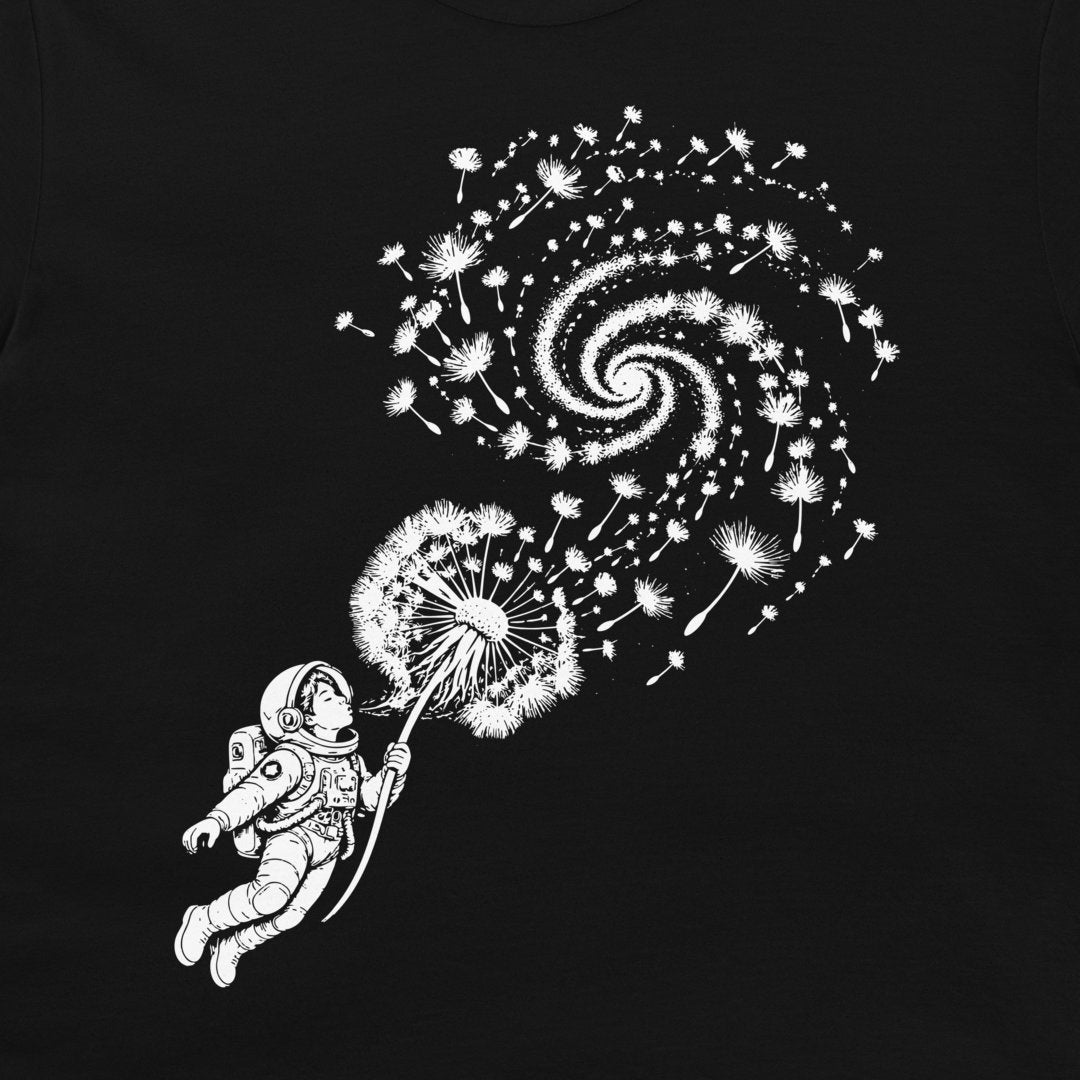 Close-up of the white astronaut and dandelion galaxy design on a black T-shirt.