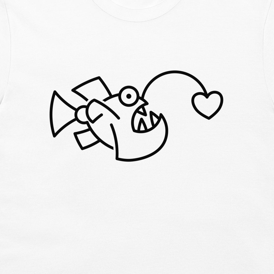 A close-up of a white t-shirt, featuring a black minimalist line art graphic of a fish with a heart-shaped mouth.