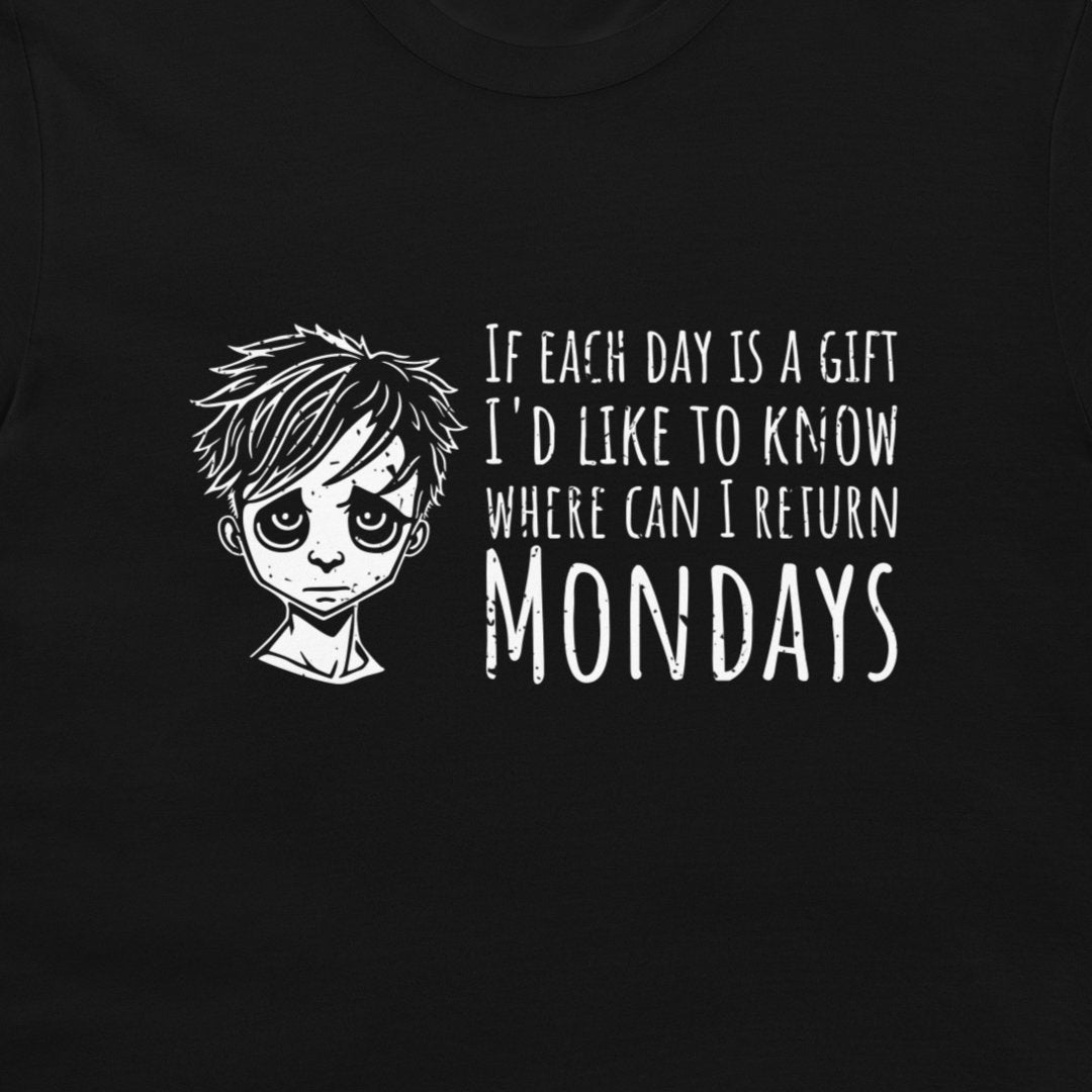 A close-up of a black t-shirt featuring a white graphic print of a sad anime-style boy next to the text 'IF EACH DAY IS A GIFT I'D LIKE TO KNOW WHERE CAN I RETURN MONDAYS'.