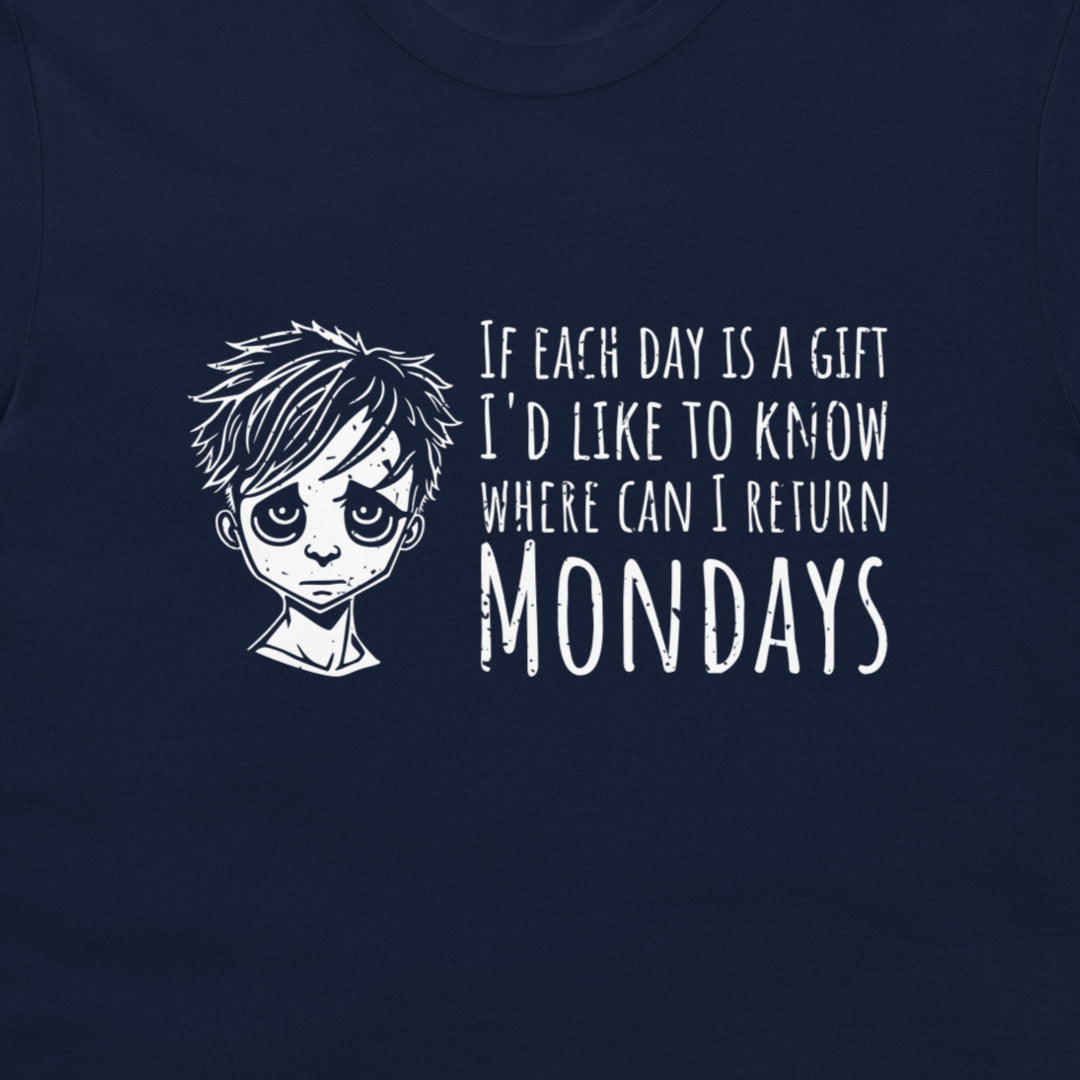 A close-up of a navy blue t-shirt featuring a white graphic print of a sad anime-style boy next to the text 'IF EACH DAY IS A GIFT I'D LIKE TO KNOW WHERE CAN I RETURN MONDAYS'.