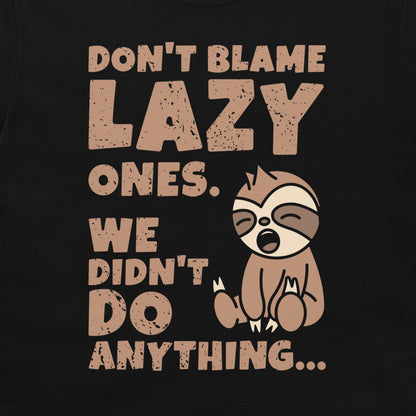 A black graphic t-shirt featuring a distressed beige print that reads 'DON'T BLAME LAZY ONES. WE DIDN'T DO ANYTHING.