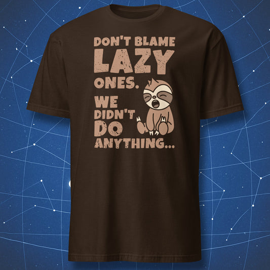 funny sloth T-shirt on dark brown background with tan cartoon sloth and text “Don’t blame lazy ones, we didn’t do anything”