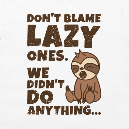 A white t-shirt featuring a brown distressed text graphic that reads 'DON'T BLAME LAZY ONES. WE DIDN'T DO ANYTHING.