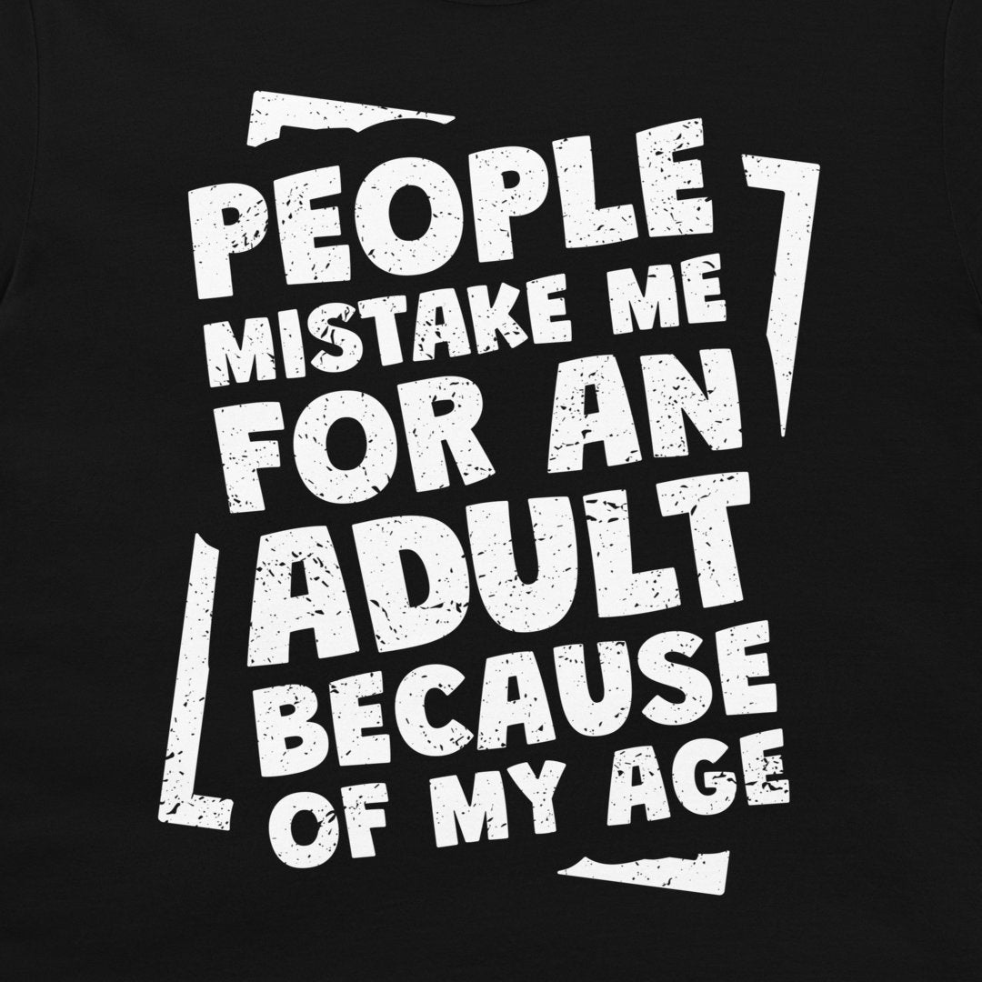 A close-up of a black garment, likely a t-shirt, featuring a distressed white graphic print with the text 'PEOPLE MISTAKE ME FOR AN ADULT BECAUSE OF MY AGE'.