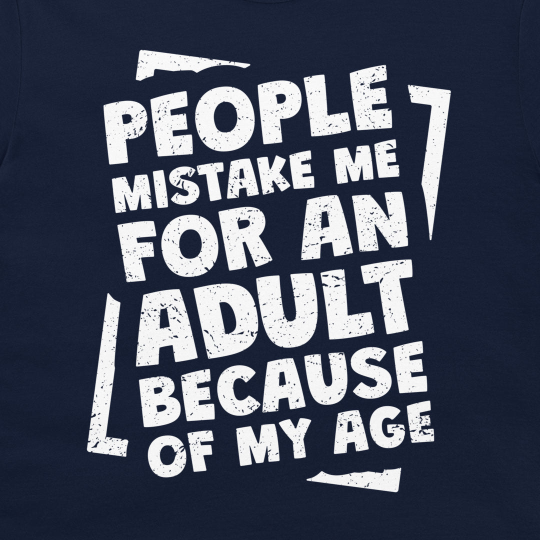 A close-up of a navy blue graphic t-shirt featuring a distressed white typographic design that reads 'PEOPLE MISTAKE ME FOR AN ADULT BECAUSE OF MY AGE'.