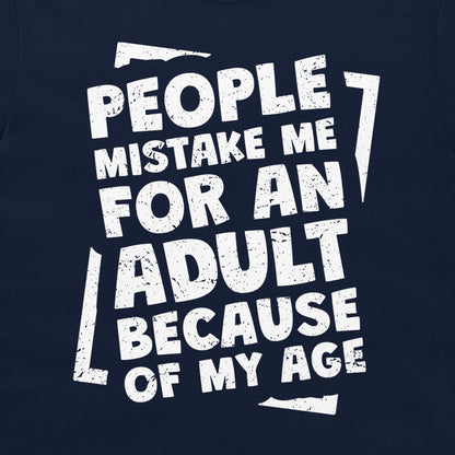 A close-up of a navy blue graphic t-shirt featuring a distressed white typographic design that reads 'PEOPLE MISTAKE ME FOR AN ADULT BECAUSE OF MY AGE'.