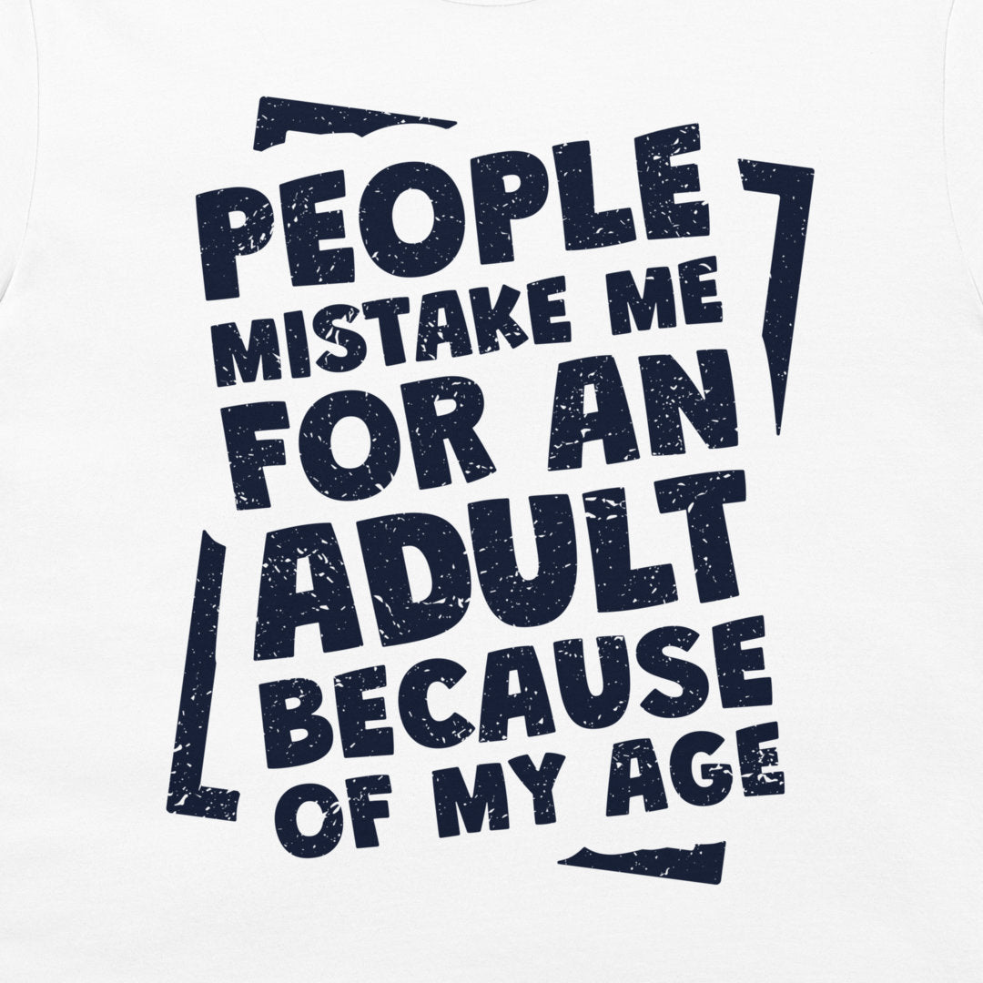 A close-up of a white t-shirt featuring a bold, distressed navy blue graphic print with the text 'PEOPLE MISTAKE ME FOR AN ADULT BECAUSE OF MY AGE'.