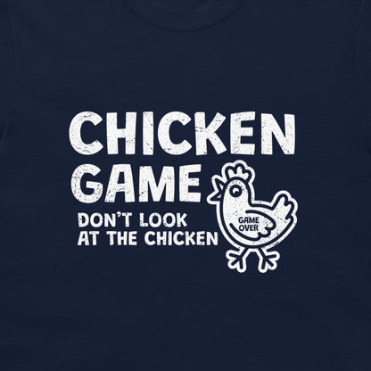 A close-up of a navy blue t-shirt, featuring a distressed white graphic print that reads 'CHICKEN GAME DON'T LOOK AT THE CHICKEN' alongside a cartoon chicken with 'GAME OVER' written inside.