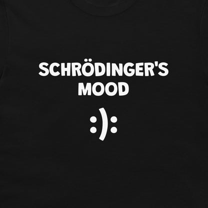 A close-up of a black t-shirt featuring the white printed text 'SCHRÖDINGER'S MOOD' above a white smiley face symbol.