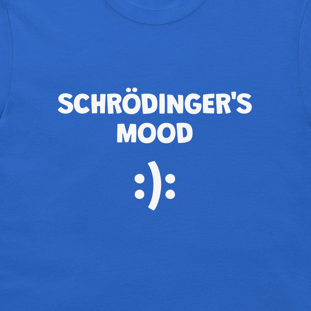 A close-up of a royal blue t-shirt featuring the white printed text 'SCHRÖDINGER'S MOOD' above a white smiley face symbol.