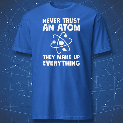 funny science T-shirt on white fabric featuring an atom graphic and text “Never Trust an Atom – They Make Up Everything” in bold distressed lettering