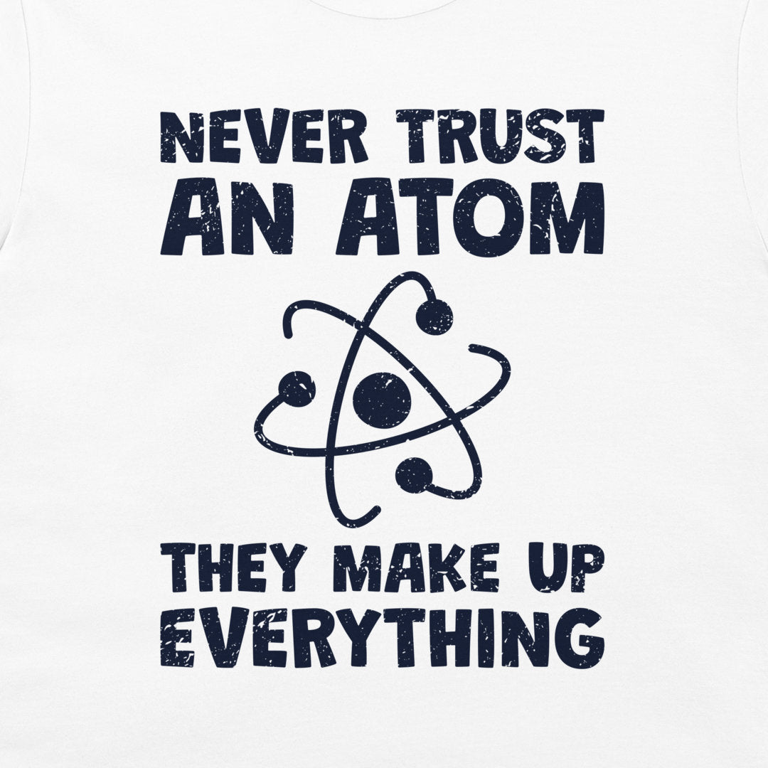 White tank top featuring a dark navy blue graphic print with the text 'NEVER TRUST AN ATOM THEY MAKE UP EVERYTHING' and a stylized atom icon.