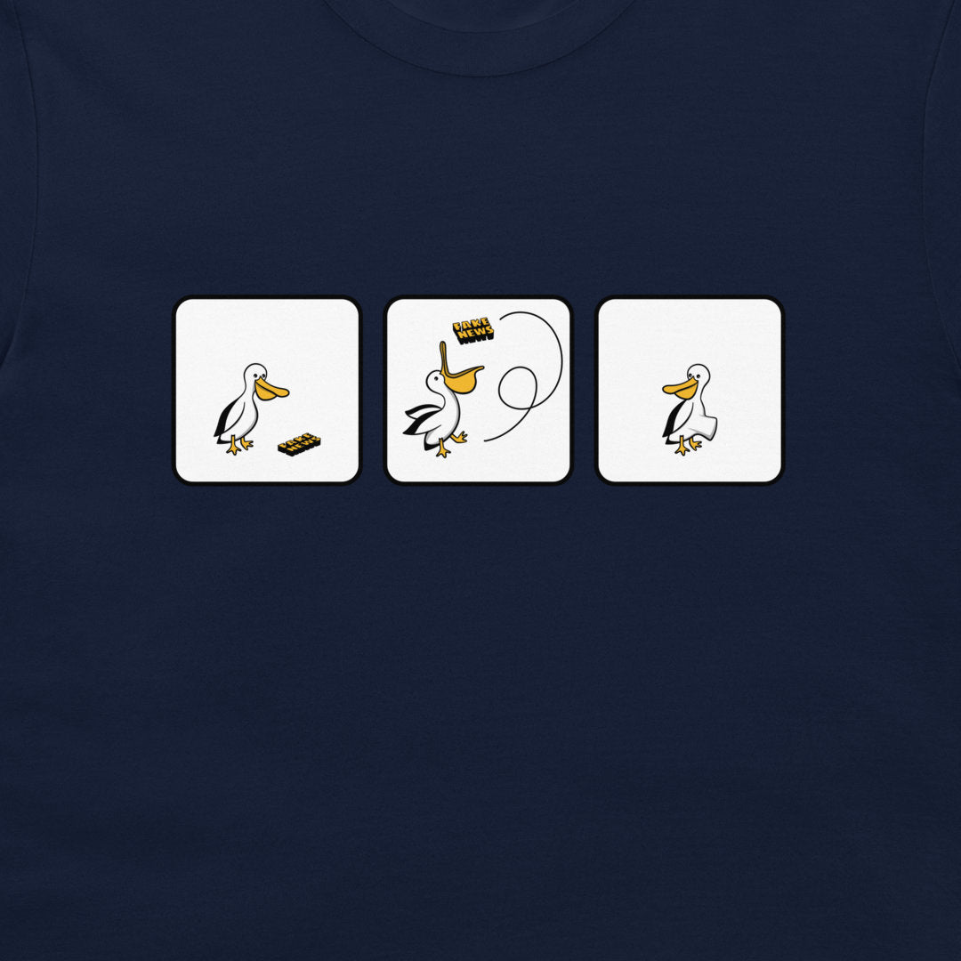 A close-up of a navy blue t-shirt featuring a graphic print of three white square panels with a cartoon pelican and fake news.