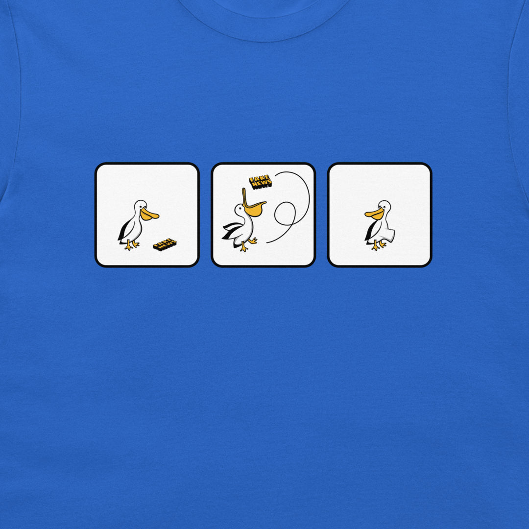 A close-up of a blue t-shirt featuring a graphic print of three white square panels with a cartoon pelican and fake news.