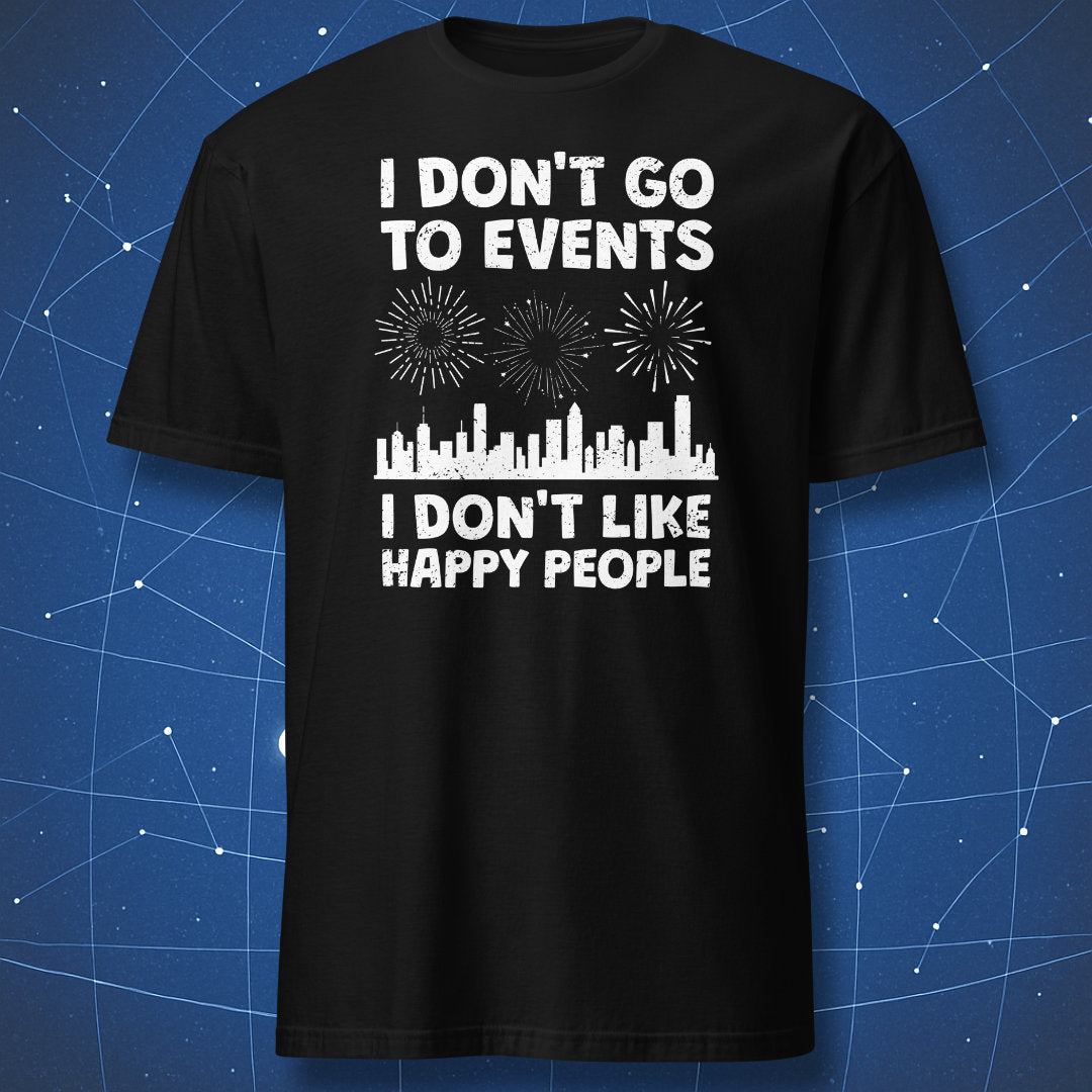 funny introvert T-shirt on black fabric with distressed white text reading I Don’t Go to Events I Don’t Like Happy People and city skyline with fireworks
