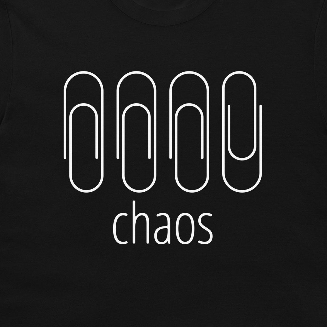 A close-up of a black t-shirt featuring a white graphic design of four paperclip-like shapes above the word 'chaos' in lowercase sans-serif font.