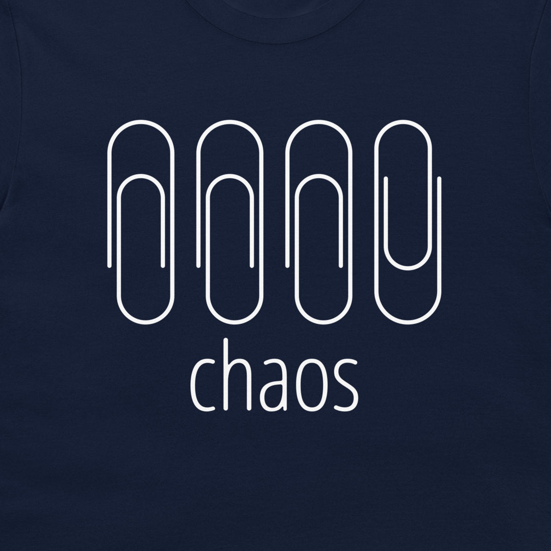 A close-up of a navy blue t-shirt featuring a white graphic of four paperclip-like shapes above the word 'chaos' in lowercase sans-serif font.