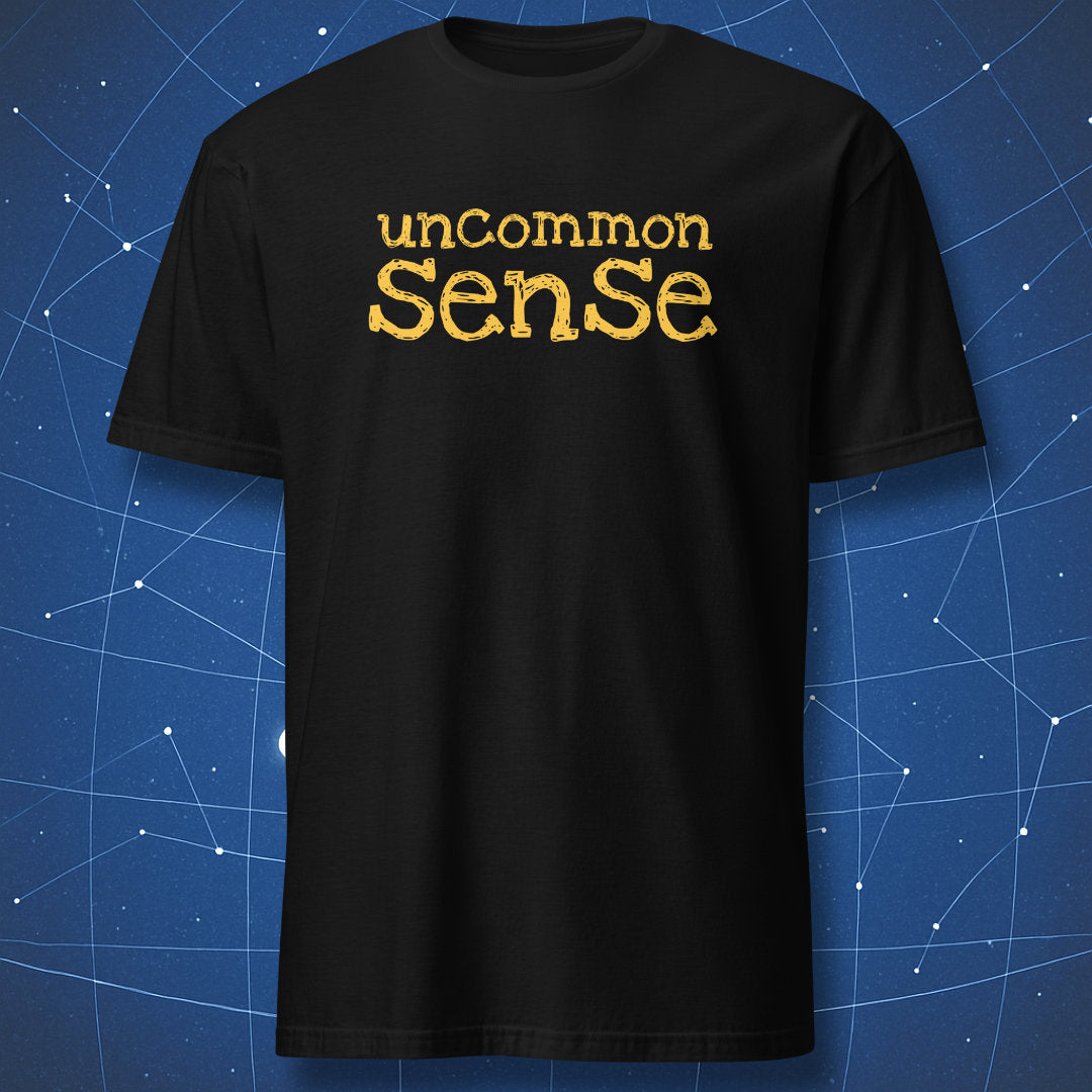 funny intellectual T-shirt on black fabric with yellow text reading uncommon sense in playful bold font
