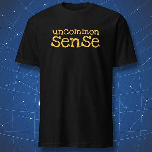funny intellectual T-shirt on black fabric with yellow text reading uncommon sense in playful bold font