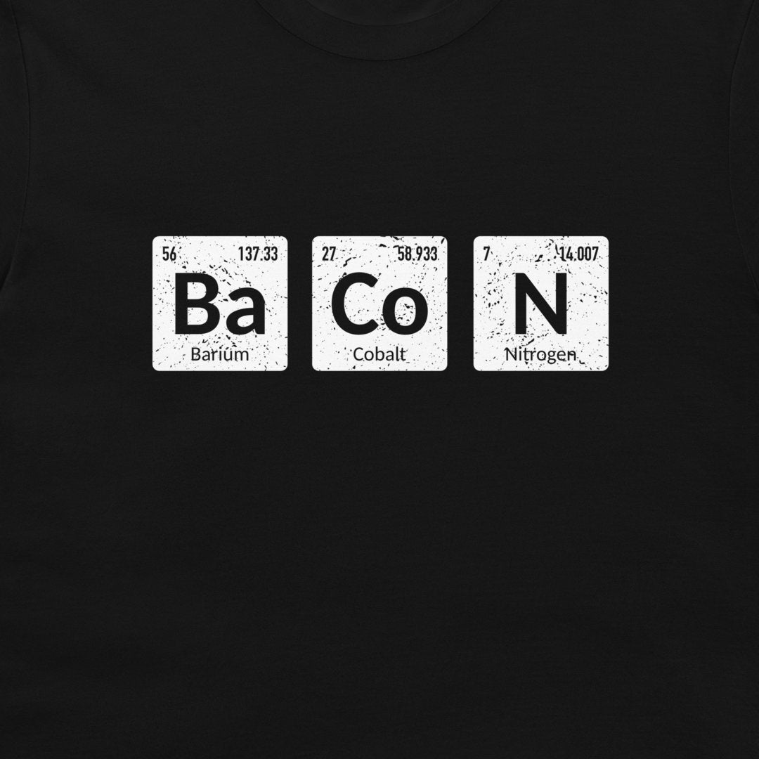 A close-up of a black garment, likely a t-shirt, featuring a white graphic print of three periodic table style tiles spelling out 'BaCoN'.
