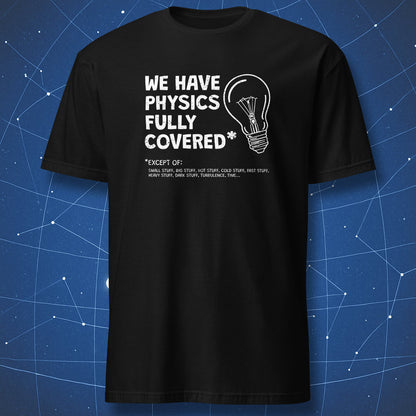 funny physics T-shirt on black fabric showing a light bulb and text “We have physics fully covered* except of small, big, dark, heavy, fast stuff”