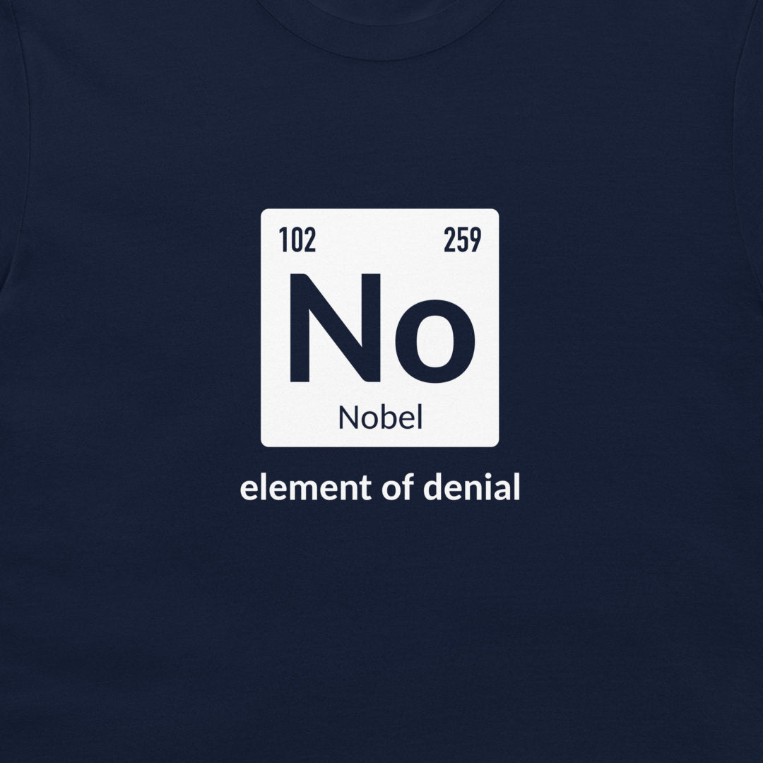 A black t-shirt featuring a white periodic table-style graphic with the word 'No' and 'Nobel' underneath, plus the phrase 'element of denial' printed below in white text.
