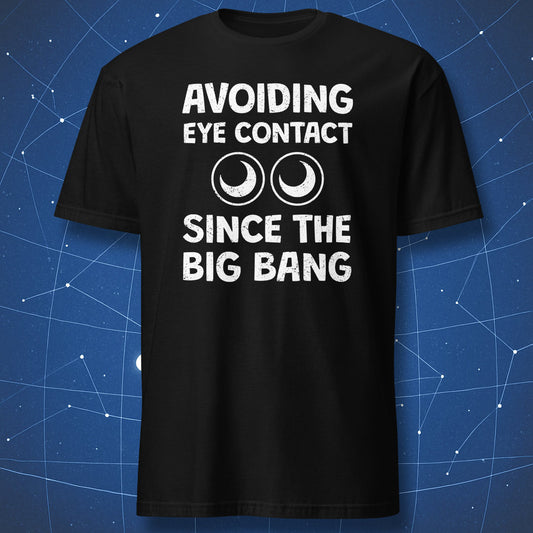 funny introvert T-shirt on black fabric with text “Avoiding eye contact since the Big Bang” and two cartoon eyes graphic