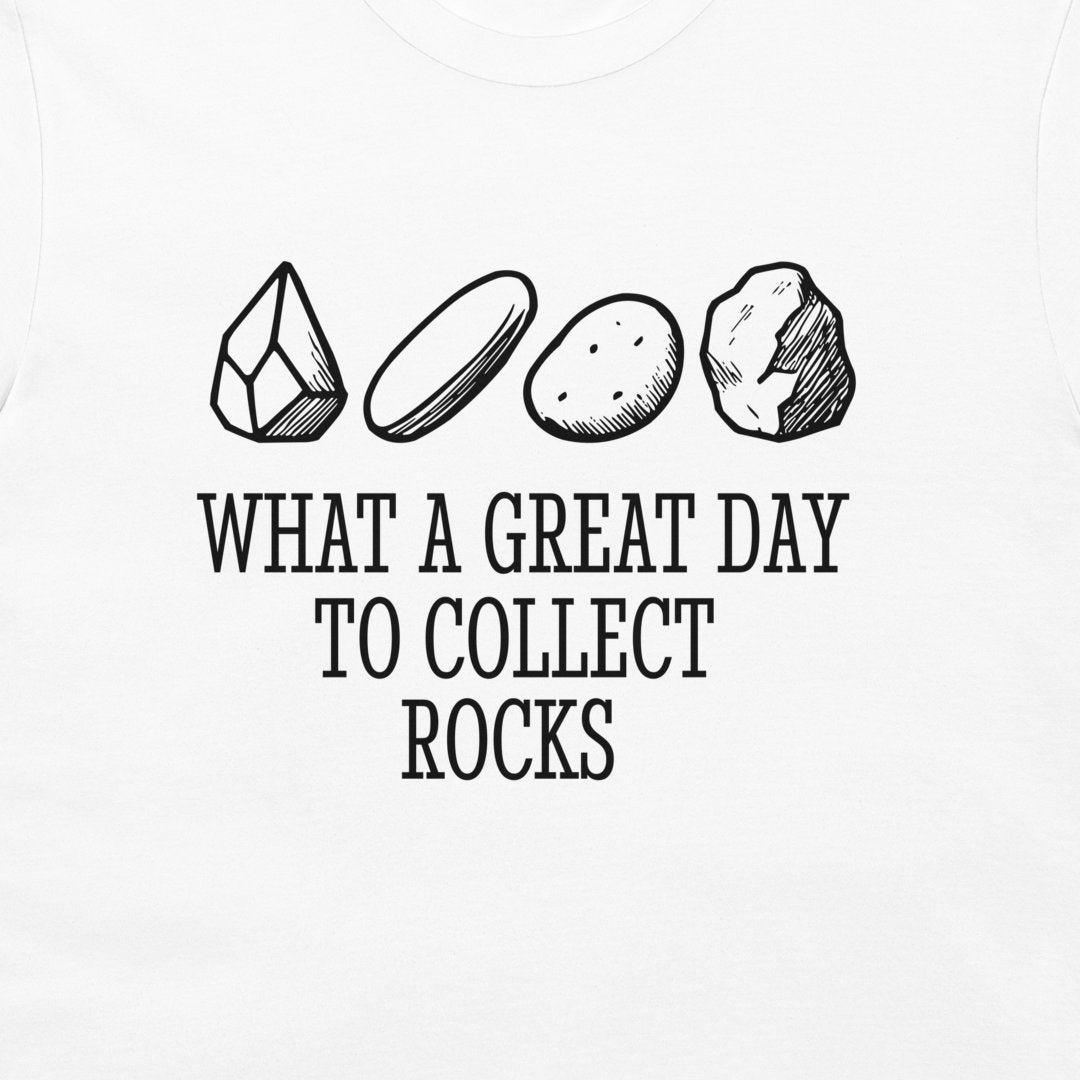 White t-shirt featuring a black graphic print of four different rocks and the text 'WHAT A GREAT DAY TO COLLECT ROCKS'.