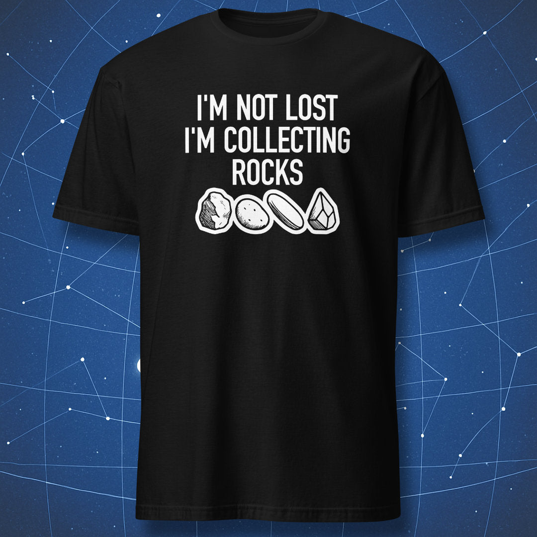 nerdy geologist T-shirt on black background featuring white text “I’m not lost I’m collecting rocks” and sketches of stones