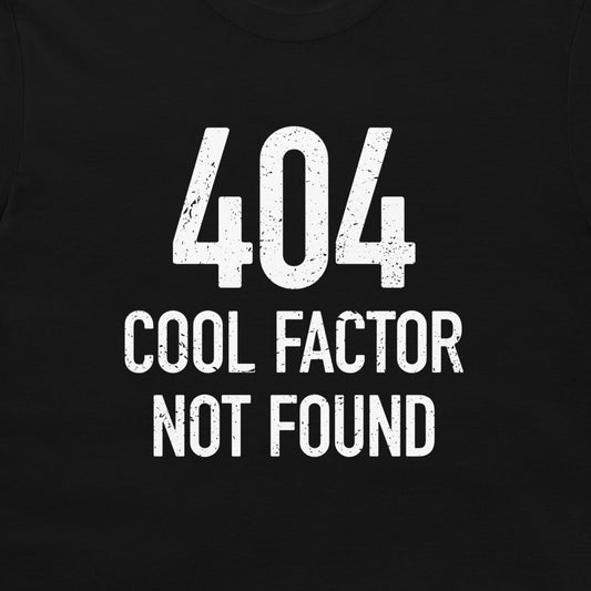 A close-up of a black t-shirt, featuring a distressed white graphic print that reads '404 COOL FACTOR NOT FOUND'.