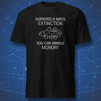 funny paleontology T-shirt on black fabric showing white text “Survived a Mass Extinction You Can Handle Monday” with a coelacanth fish illustration