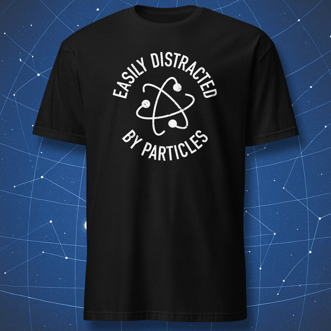 Black T-shirt with white atom illustration and text “Easily Distracted by Particles.”