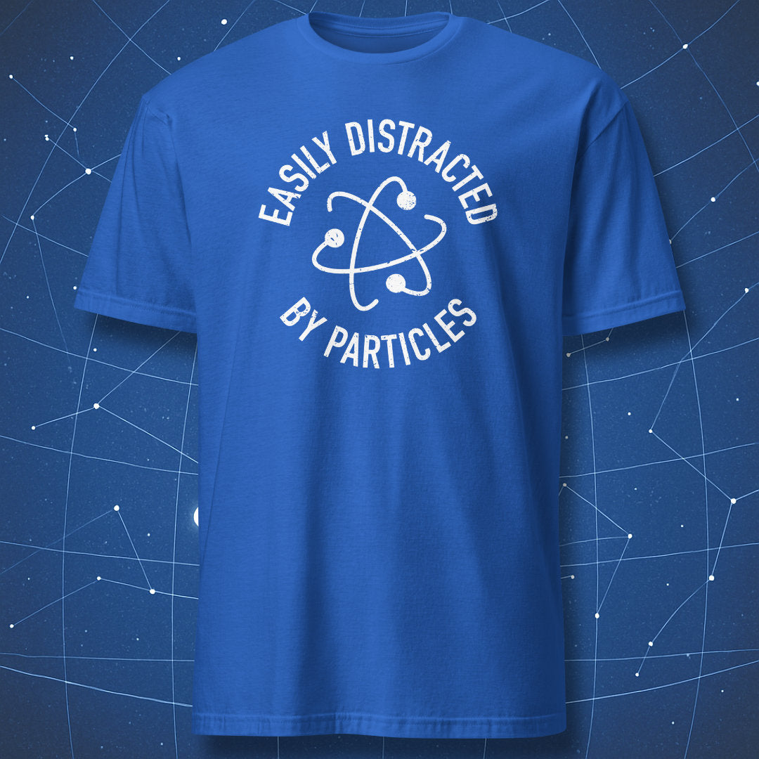 Royal blue T-shirt featuring a white atom graphic and curved text “Easily Distracted by Particles.”