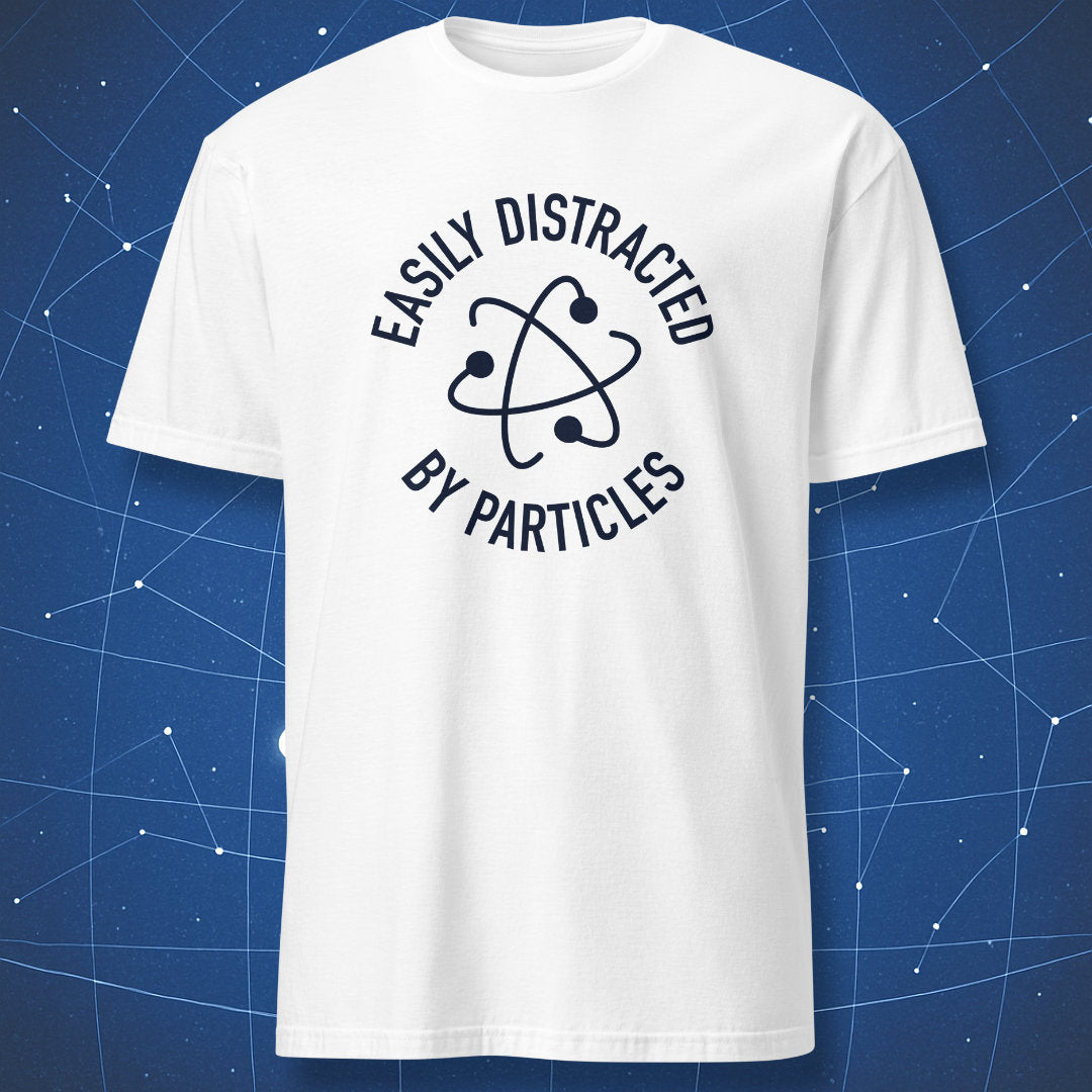 White T-shirt with black atom symbol and text “Easily Distracted by Particles.”