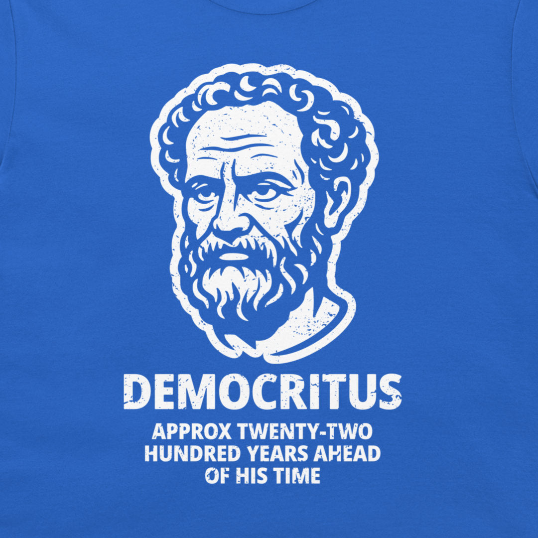 A close-up of a royal blue t-shirt featuring a white distressed graphic of Democritus' portrait with the text 'DEMOCRITUS APPROX TWENTY-TWO HUNDRED YEARS AHEAD OF HIS TIME'.