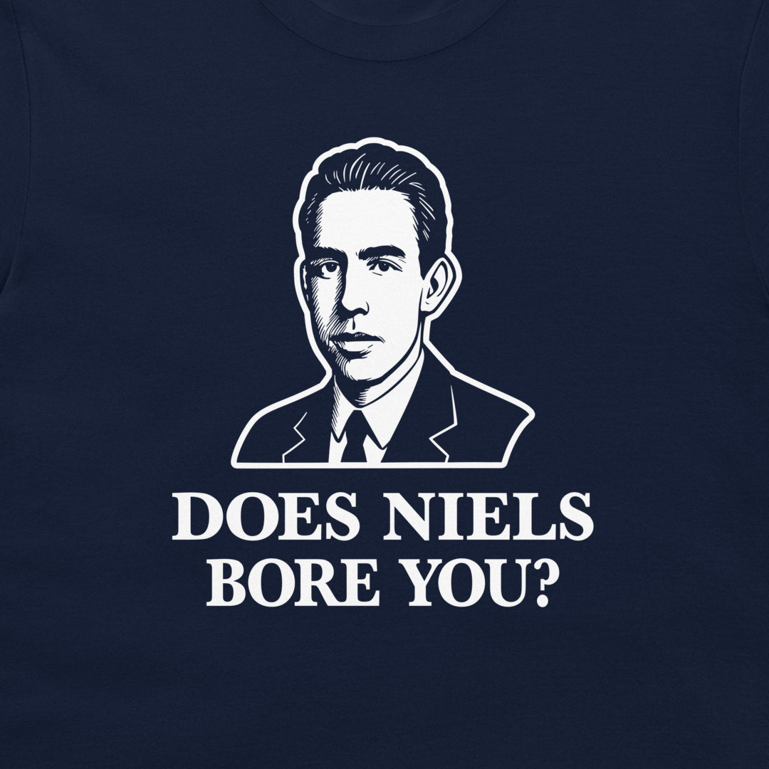 A close-up of a navy blue t-shirt featuring a white graphic print of a man in a suit and the text 'DOES NIELS BORE YOU?'.