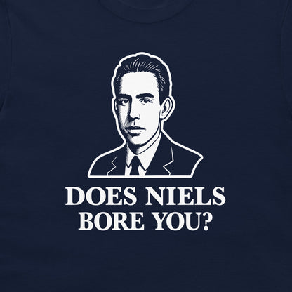 A close-up of a navy blue t-shirt featuring a white graphic print of a man in a suit and the text 'DOES NIELS BORE YOU?'.