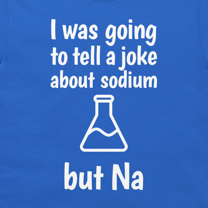A close-up of a blue T-shirt with white printed text reading 'I was going to tell a joke about sodium but Na' and a white flask outline graphic.
