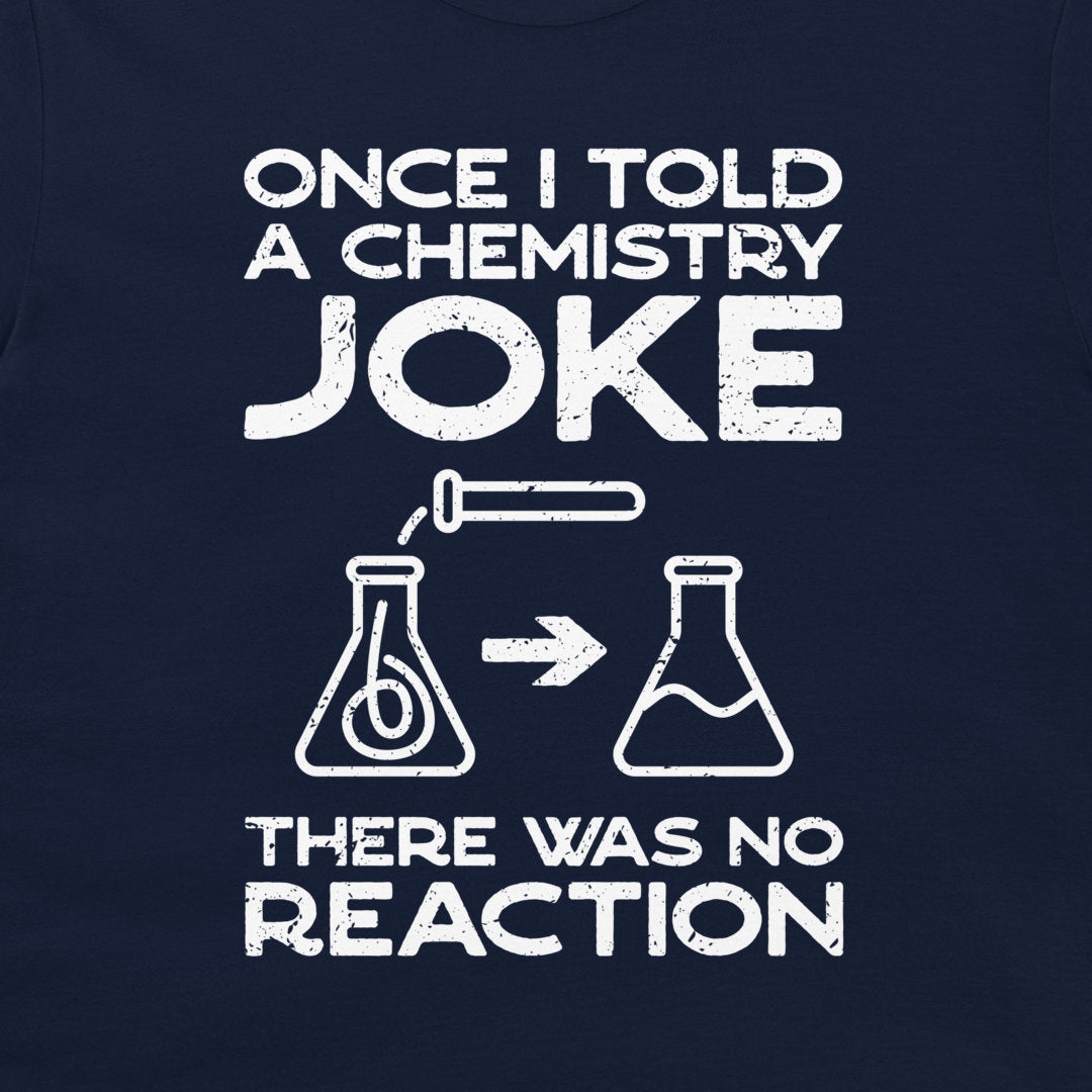A close-up of a navy blue garment, likely a t-shirt, featuring a white distressed graphic print with the text 'ONCE I TOLD A CHEMISTRY JOKE THERE WAS NO REACTION' and simple flask illustrations.