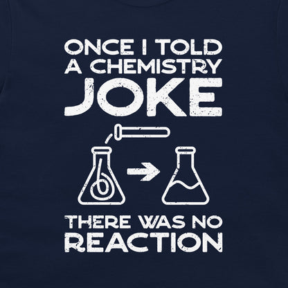 A close-up of a navy blue garment, likely a t-shirt, featuring a white distressed graphic print with the text 'ONCE I TOLD A CHEMISTRY JOKE THERE WAS NO REACTION' and simple flask illustrations.
