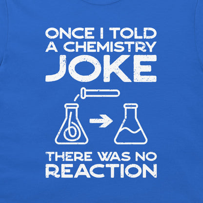 A close-up of a blue T-shirt with a white distressed graphic print that reads 'ONCE I TOLD A CHEMISTRY JOKE THERE WAS NO REACTION' with simple flask illustrations.